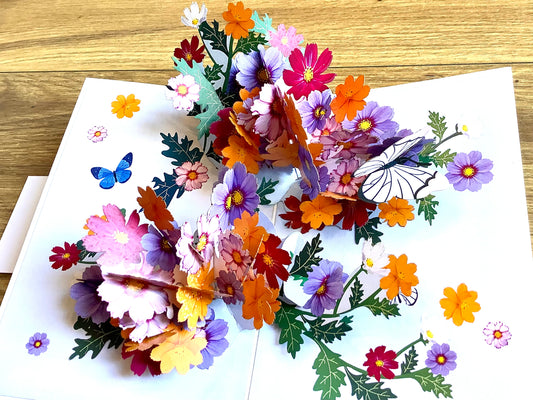 Dreidimensionale Klappkarte, aus der sich beim Öffnen ein leuchtend buntes Blumenbouquet entfaltet. Fairtrade aus Vietnam.