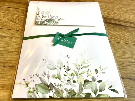 Briefpapier mit grünen Blättern unten
