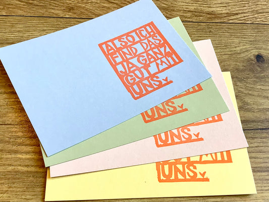 Postkarte mit handgestempeltem Aufdruck "Also ich find das ja ganz gut mit uns". Karton in pastell-blau, -grün, -rosa oder -gelb.
